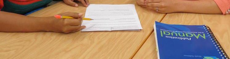 Staff and SIU student working together on a writing paper